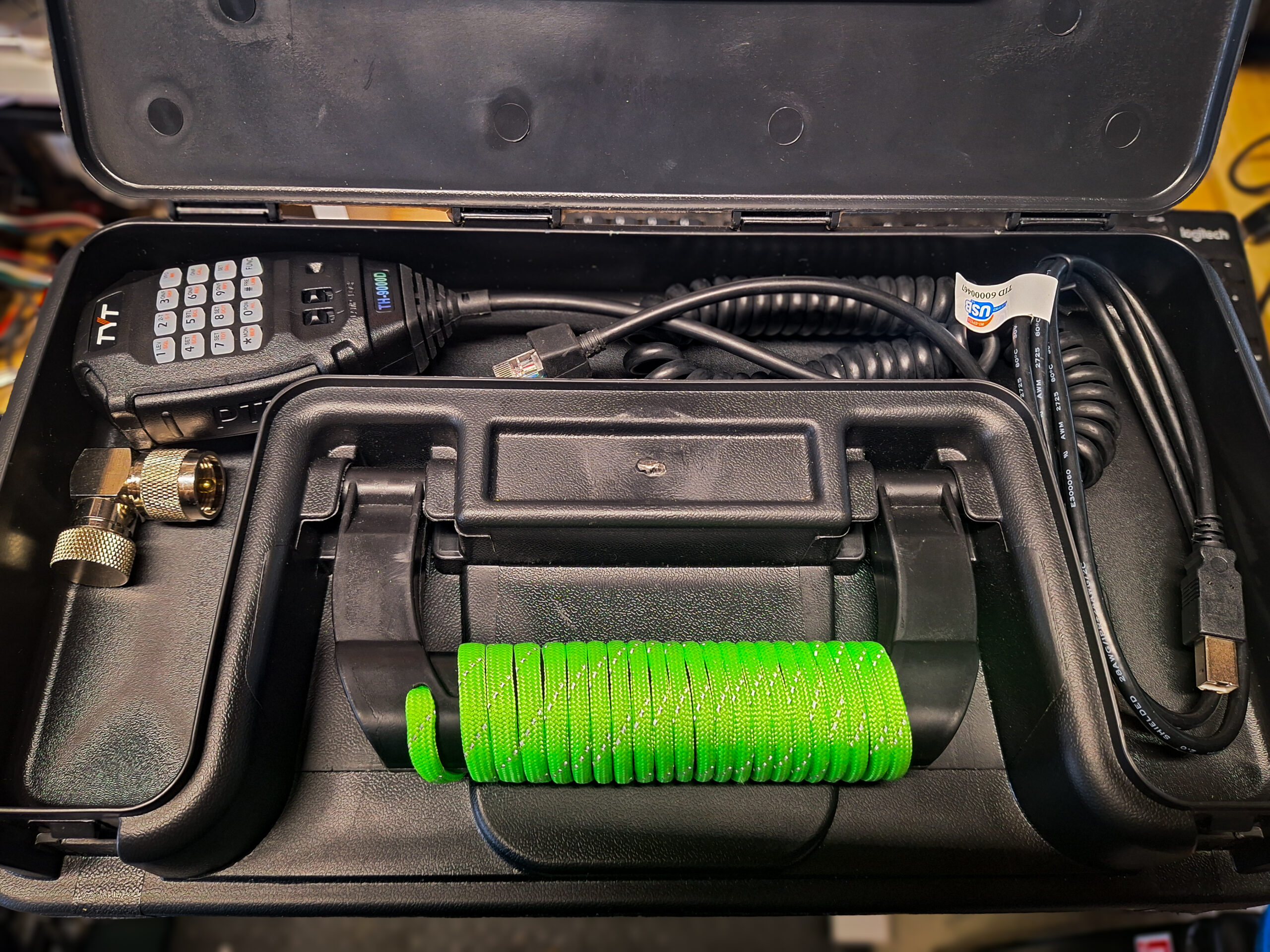 Open top storage compartment of Utility Box with microphone and various other accessories.
